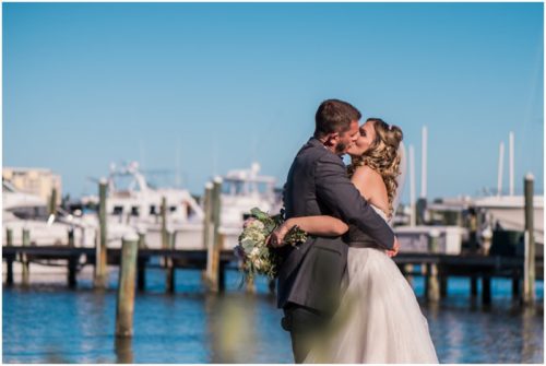 couple kissing with boats in background at Crystal Ballroom Wedding