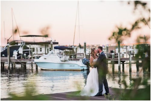 Couple kissing behind trees at Crystal Ballroom Wedding