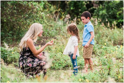 Melbourne Florida Family Photographer Mom showing flower to kids on path photo by Liz Cowie Photography