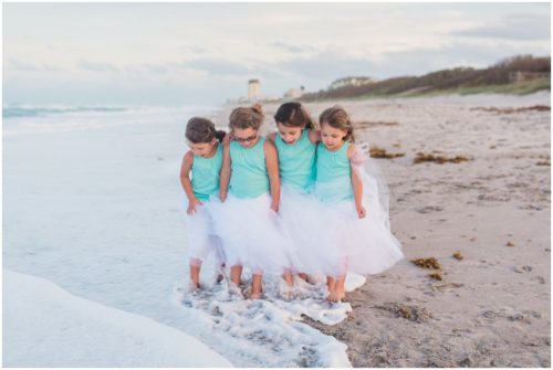 Little girls with toes in the water during Melbourne Beach Family Photography session