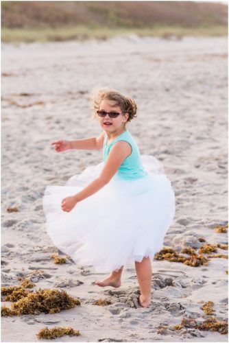 little girl spinning on beach during Melbourne Beach Family Photography session