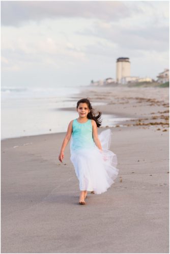 Cute girl walking on beach during Melbourne Beach Family Photography session