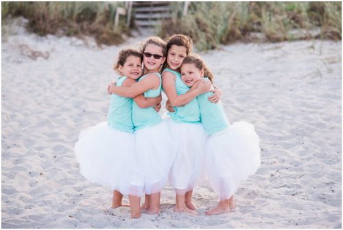 Little girl cousins hugging during Melbourne Beach Family Photography session