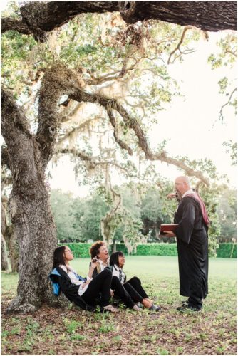 Fun Family Portraits Family in robes and wands with Dad reading to family