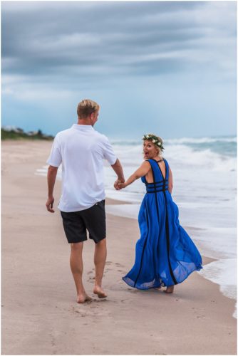 Walking hand in hand on beach during storm