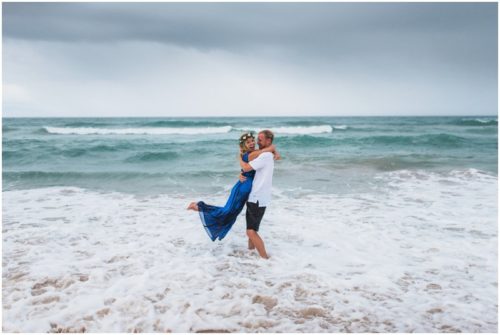 Groom spinning bride in ocean during Melbourne Beach Florida engagement session