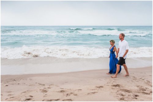 Couple walking along beach during Melbourne Beach Florida engagement session