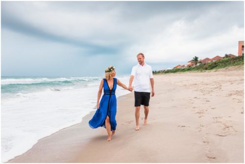 couple walking hand in hand during Melbourne Beach Florida engagement