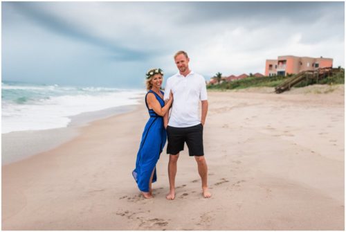 Couple standing in wind on beach during Melbourne Beach Florida engagement