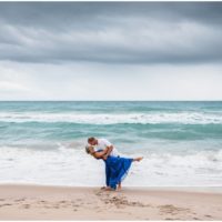 Groom dipping bride during Melbourne Beach engagement session