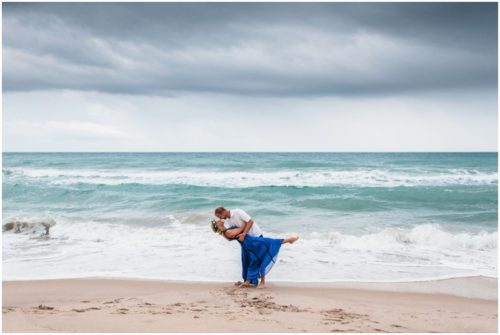 Groom dipping bride during Melbourne Beach engagement session