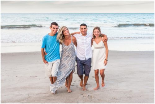 Adorable family walking on beach