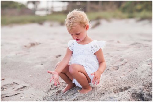 two year old cute white lace outfit during Melbourne Beach Family Portraits