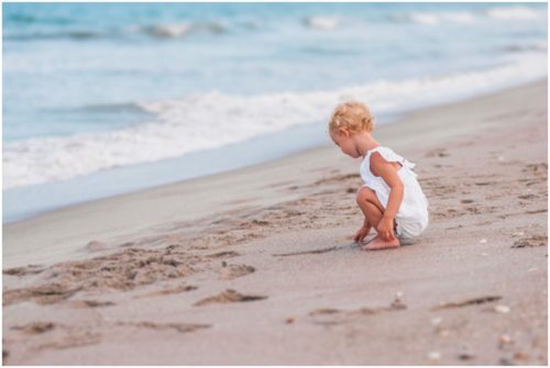 Back of two year old cute white lace outfit during Melbourne Beach Family Portraits