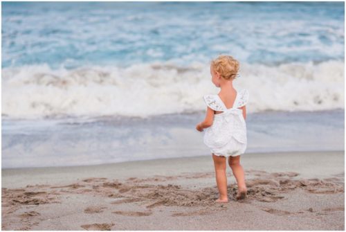 Back of two year old cute white lace outfit during Melbourne Beach Family Portraits