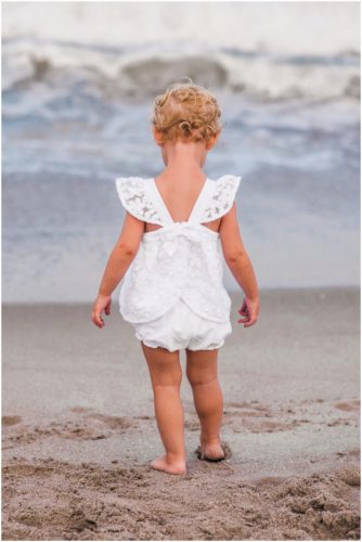 Back of two year old cute white lace outfit during Melbourne Beach Family Portraits