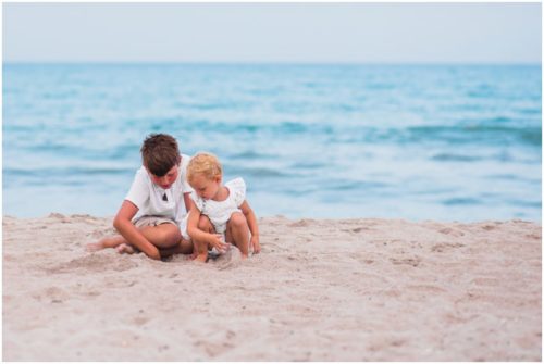 Kids making sand castle together during Melbourne Beach Family Portraits