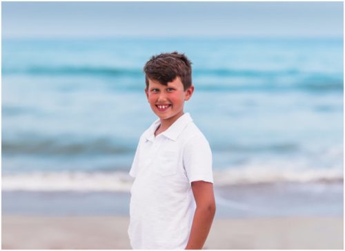 Just big brother in white shirt with ocean during Melbourne Beach Family Portraits