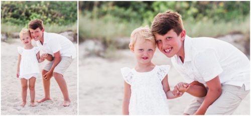 Siblings sitting with dunes in the background during Melbourne Beach Family Portraits
