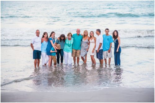 Whole family in water during family beach vacation portraits in Melbourne Beach Florida