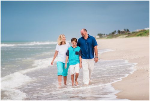 Family walking with arms around each other during their fun family beach portraits
