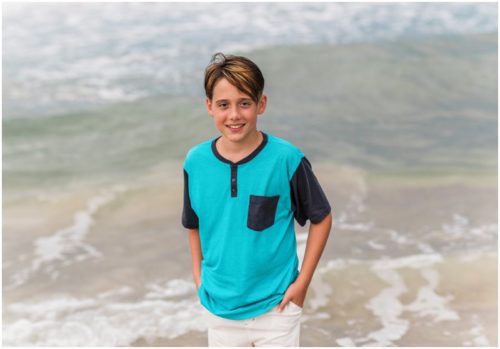 Son near the water during fun family portraits