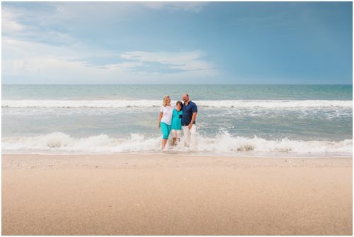 Family walking with arms around each other during their fun family beach portraits