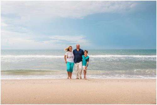 Family walking with arms around each other during their fun family beach portraits