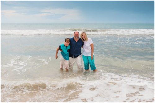 Family in water during their fun family beach portraits