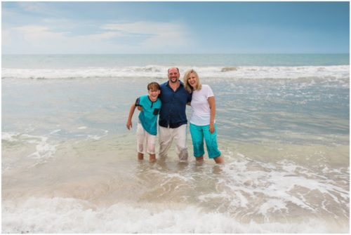 Family in water during their fun family beach portraits