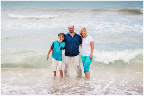 Family in water during their fun family beach portraits