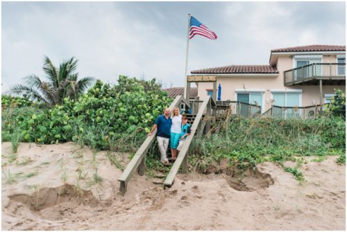 Family on stairs of rental house during their fun family beach portraits