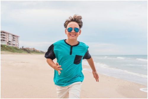 Boy running with sun glasses on