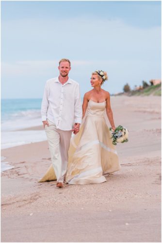 couple walking on beach during gorgeous Melbourne Beach wedding