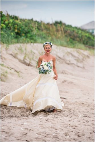 Bride walking down beach during gorgeous Melbourne Beach wedding