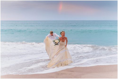 couple playing in ocean during gorgeous Melbourne Beach wedding