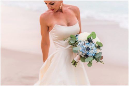 Bride playing in ocean during gorgeous Melbourne Beach wedding