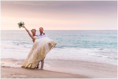 Couple playing by ocean during gorgeous Melbourne Beach wedding