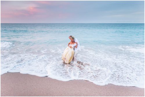 Couple playing by ocean during gorgeous Melbourne Beach wedding