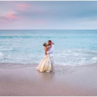 Couple playing by ocean during gorgeous Melbourne Beach wedding