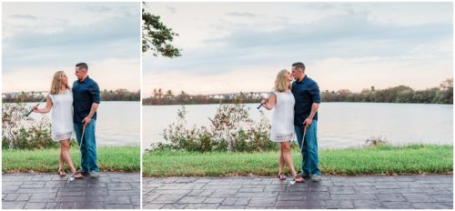 Couple together with golf clubs during Vero Beach engagemen