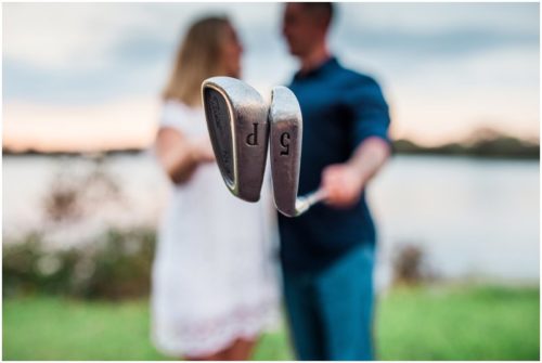 Couple together with golf clubs during Vero Beach engagemen