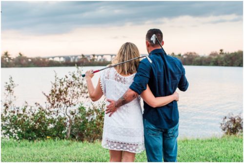 Couple together with golf clubs during Vero Beach engagemen