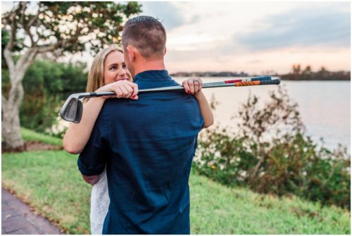 Couple together with golf clubs during Vero Beach engagemen