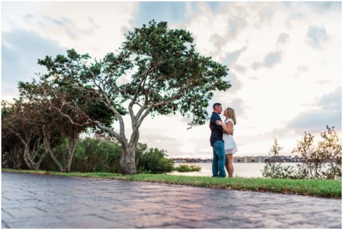Couple hugging under trees during Vero Beach engagemen