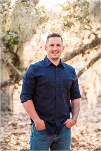 Groom under oak trees during Vero Beach engagemen