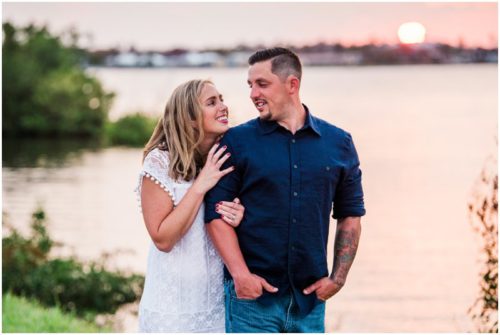 Couple smiling by shores of Indian River Lagoon during Vero Beach engagement