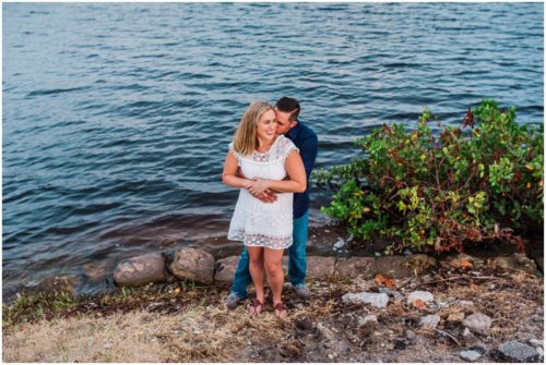 Couple smiling by shores of Indian River Lagoon during Vero Beach engagement