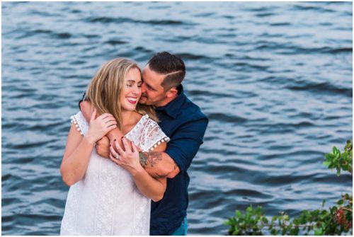 Couple smiling by shores of Indian River Lagoon during Vero Beach engagement