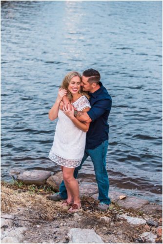 Couple smiling by shores of Indian River Lagoon during Vero Beach engagement